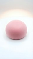 Soft pink felted wool ball isolated on white background, suitable for craft projects, textile design, and product mockups.