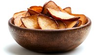 Crispy homemade apple chips in wooden bowl, healthy snack alternative for diet and nutrition. Natural dried fruit without additives.