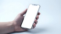 Hand holding modern smartphone with blank white screen mockup for app presentation and mobile interface design projects.