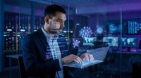 Man in business suit working on laptop with digital holographic data visualization and network interface overlays in modern server room environment for technology and innovation concepts.