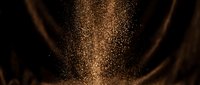 Cascading golden particles and dust flowing downward against dark background, creating elegant light effect for luxury and premium design projects.