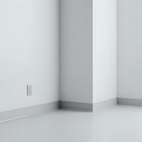 Empty white room corner with electrical outlet and baseboard molding for interior design and real estate applications.