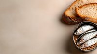 Sliced whole grain bread and canned fish in oil arranged on neutral background, suitable for food photography, cooking blogs, and culinary content.