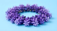 Purple flower crown wreath with small blooms on light blue background, floral headpiece accessory for spring celebrations and festivals.