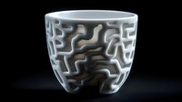 White ceramic bowl with intricate maze-like pattern carved into surface creates dramatic light and shadow effect against dark background, modern artistic design.