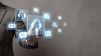 Businessman touching digital communication icons interface with customer service and support symbols on modern technology background.