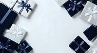 Assorted gift boxes with navy and white ribbons arranged on white background, isolated and ready for design use on promotional materials, greeting cards, and holiday campaigns.