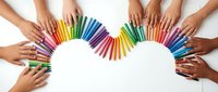 Diverse hands arranging colorful pencils in heart shape on white background symbolizing unity, creativity, teamwork and collaborative art education.