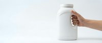 Hand holding white cylindrical supplement bottle with cap on neutral background, isolated for packaging mockup and product design use.