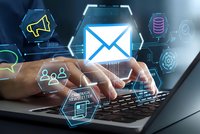 Digital email marketing concept with businessman hands typing on laptop keyboard surrounded by glowing communication icons and network symbols.