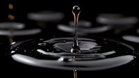Single water drop creating ripple effect on dark liquid surface with dramatic lighting, capturing moment of impact in high-speed macro photography. Artistic minimalist composition.