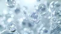 Transparent soap bubbles floating in soft blue atmosphere, creating dreamy bokeh effect for cosmetic or cleansing product advertising.