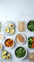 Healthy meal prep containers with fresh vegetables, avocado, grilled chicken and quinoa on marble background for balanced nutrition planning.