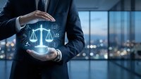 Businessman in suit holding glowing justice scales hologram with legal icons, symbolizing law, justice, and digital legal technology.