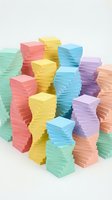 Stacks of colorful adhesive notes in green, pink, yellow, blue, purple, and peach arranged in organized piles on white background for office and organizational design projects.