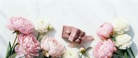 Romantic flat lay with pink peonies, white ranunculus flowers and luxury chocolate gift box on white background for Valentine's Day celebration.