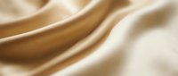 Smooth golden satin fabric with soft flowing folds and elegant waves, luxury textile texture background for fashion and design projects.