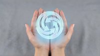 Hands protecting glowing blue energy sphere with swirling patterns symbolizing renewable power, environmental protection and sustainable technology solutions.
