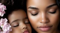 African American mother and daughter with natural curly hair and pink flowers, showcasing gentle skincare and beauty bonding moment with closed eyes.