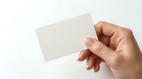 Hand holding blank white business card mockup on light background for branding and corporate identity design projects.