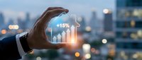 Businessman hand protecting glowing growth chart showing 15% increase against blurred city skyline at dusk for financial success concepts.
