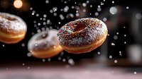 Flying chocolate glazed donuts with powdered sugar falling in motion against dark background with bokeh lights and magical sparkles. Food photography.