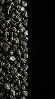 Metallic gold nuggets arranged in a vertical border against black background, showcasing wealth, luxury, and precious minerals for financial, investment, and commerce design projects.