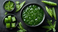 Fresh aloe vera plant pieces and gel in black ceramic bowls on dark background, natural skincare and healing ingredient for cosmetics and medicine.