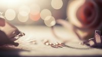 Vintage film strip and reel with warm bokeh lights creating nostalgic cinema atmosphere for movie production and entertainment projects.