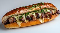 Grilled steak sandwich on toasted baguette with melted provolone cheese and fresh herbs, garnished with chopped parsley against light background.