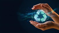 Hands protecting glowing recycling symbol with digital particles on dark blue background representing environmental conservation and sustainability concept.