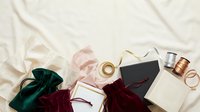 Luxury gift boxes with velvet pouches, silk ribbons and golden rings on cream fabric background for holiday shopping and special occasions.