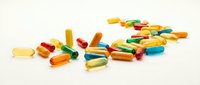 Colorful pharmaceutical capsules and pills scattered on white background. Medical supplements, vitamins, medication concept for healthcare design.