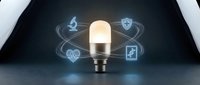 Smart LED lightbulb surrounded by glowing healthcare icons including medical cross, heartbeat, shield and stethoscope on dark background for IoT technology.