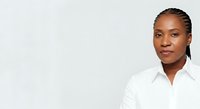 Young African American woman wearing white collared shirt against neutral background, professional headshot for corporate business portraits and corporate identity materials.