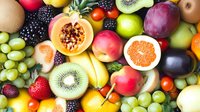 Fresh colorful fruits background with assorted tropical and berry varieties. Vibrant healthy food composition showing diverse natural produce.