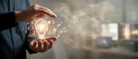 Businessman holding glowing lightbulb with digital data charts and graphs, representing innovation, business strategy, and creative solutions for corporate growth.