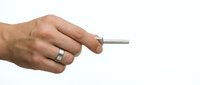 Male hand holding silver metal pen or stylus isolated on white background for business presentations and digital design projects.