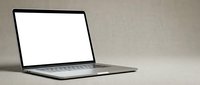Modern laptop computer with blank white screen on neutral beige background for mockup presentations and digital workspace concepts.