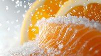 Fresh orange slice with crystalline sugar coating and water droplets in macro photography, bright citrus fruit with textured details and sparkling bokeh effect.