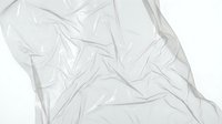 Crumpled transparent plastic sheet with wrinkled texture on white background, isolated for design, packaging, and overlay applications.