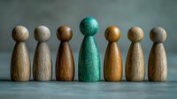 Wooden pawn figures in row with one unique turquoise piece standing out from brown and beige ones, symbolizing leadership, diversity and individuality concept.