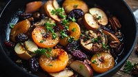 Caramelized citrus slices with roasted plums and fresh herbs in cast iron pan, glazed with honey balsamic reduction for gourmet dining presentation.