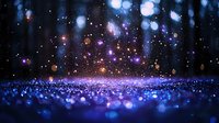 Magical glowing particles and bokeh lights creating dreamy atmosphere with blue sparkles on dark background, abstract festive backdrop for celebrations.