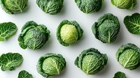 Fresh whole green savoy cabbage heads arranged in rows on white background, organic vegetables pattern layout for healthy eating and cooking concept.