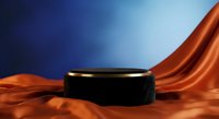 Black cylindrical podium with gold rim on flowing orange silk fabric against blue gradient background for luxury product display and branding presentations.