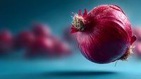 Fresh red onion with roots and skin floating against blue background for cooking and culinary design projects.