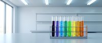 Row of colorful test tubes with rainbow liquids in modern laboratory setting for scientific research and chemical analysis experiments.