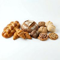Assorted fresh baked goods including croissants, artisan bread, rolls, and pastries isolated on white background for bakery, food, and culinary design use.
