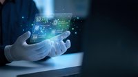 Hands in white gloves holding glowing digital tablet with circuit board interface and tech icons, representing innovation, data management, and future technology solutions.